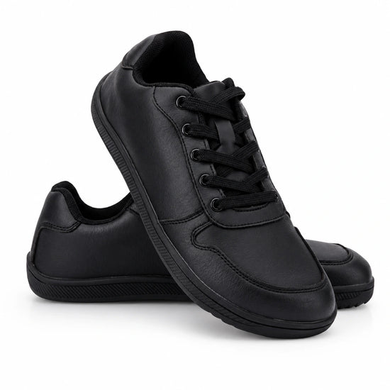 Diseño casual elegante en negro total, cordones planos y costuras reforzadas.